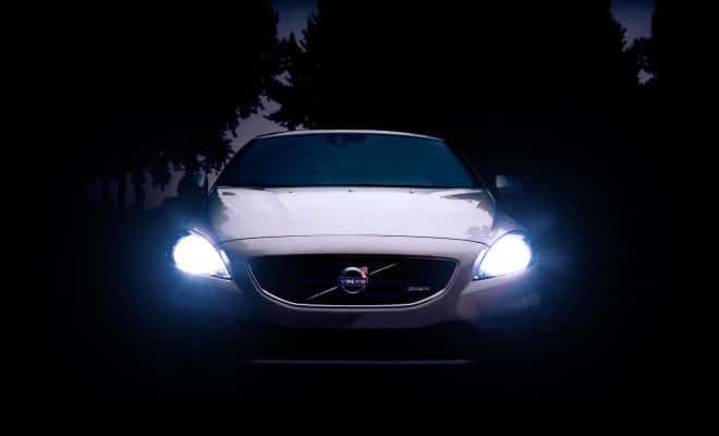 silver Volvo car with headlights on during night